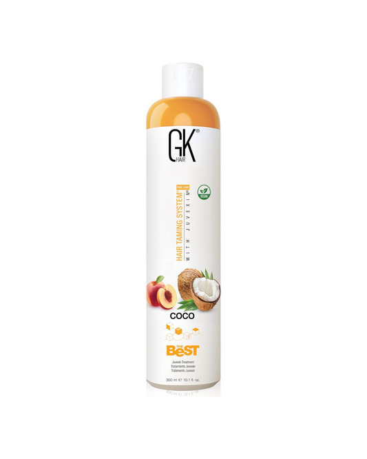 Bottle of GK Hair product with coconut and apple graphics on a white background