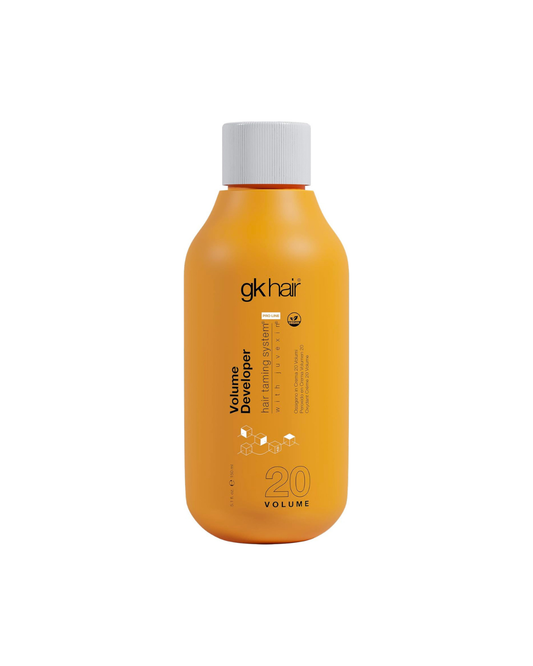 Orange bottle of gk hair Volume Developer on a white background