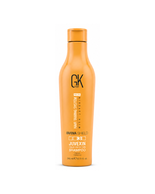 Orange shampoo bottle with 'GK' branding on a white background